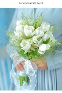 Detailed view of thickened kraft paper wrapping white tulips and green foliage