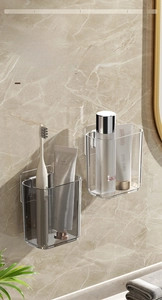 Detail view of wall-mounted acrylic bathroom organizers in transparent and smoke grey