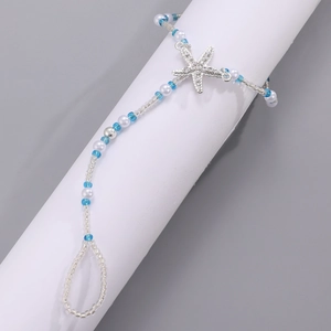 Detailed view of beaded barefoot sandal with starfish pendant for beach vacation