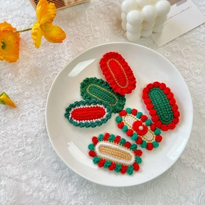 Handmade crochet Christmas hair clips set with festive patterns on a lace background