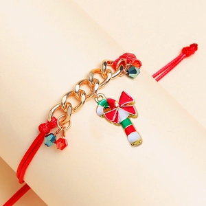 Detail view of woven red Christmas bracelet with gold chain and candy cane charm