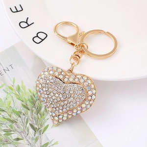 Close-up of golden heart keychain featuring dense rhinestones and lobster clasp detail