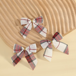 Classic red and black buffalo plaid Christmas bows on a rustic wooden display tray