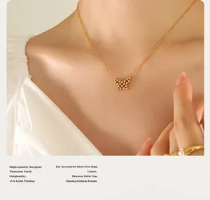 Detailed view of 18K gold plated butterfly necklace worn on a woman's collarbone
