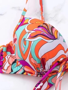 Detail of floral print bikini top with underwire support and adjustable halter straps