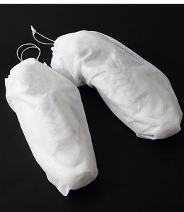 Macro detail of breathable white non-woven shoe dust bag with drawstring closure