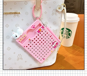Close-up of pink cat magnetic steel ball drawing board toy hanging on a white bag