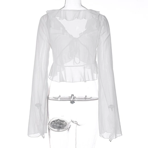 Detail of white ruffle trim and lace-up neck on sheer long-sleeve chiffon blouse