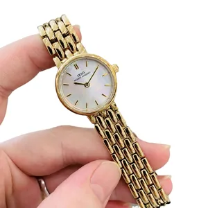 IBSO women's mini gold watch with mother of pearl dial and stainless steel chain strap