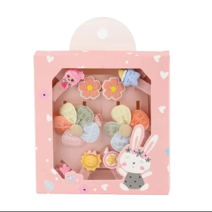 Rosa Geschenkbox mit bunten Blumen- und Stern-Haaraccessoires für kleine Mädchen