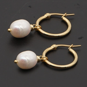 Minimalist gold hoop earrings with baroque freshwater pearl pendants on gray backdrop