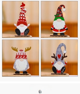 Detail display of four wooden Christmas gnome desk ornaments with Merry Christmas text