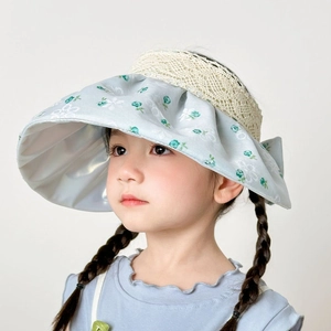 Detail of light blue floral lace sun hat with silver UV lining and decorative bow