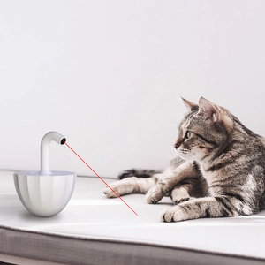 Automatic white laser cat toy showing the red laser point on a soft indoor surface