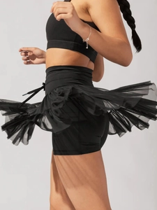 Detail of high waist black layered mesh skirt with drawstring and built-in shorts