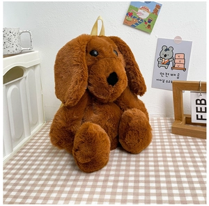 Detail of soft brown plush dog backpack featuring fluffy texture and yellow handle strap