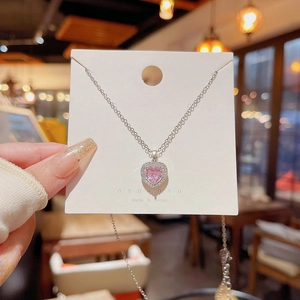 Pink heart pendant necklace in silver stainless steel held on a brand display card