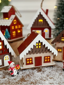 Detail of wooden Christmas house with LED warm light on snow background for holiday decor