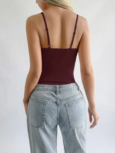 Back view of a deep red Y2K style tube top bodysuit paired with light blue jeans