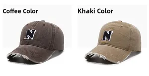 Detail of vintage washed baseball caps with N letter embroidery and distressed brim edge