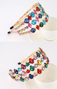 Close-up of colorful rhinestones and faux pearls on a gold baroque style headband