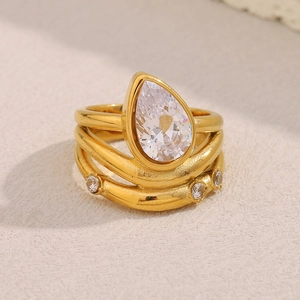 Macro detail of triple-layer 18K gold-plated ring with pear-cut cubic zirconia