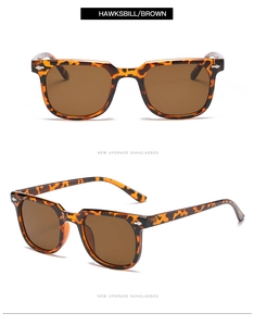Close-up of hawksbill square sunglasses with brown lenses and silver rivets detail