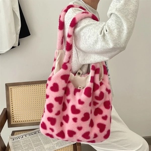 Detail of pink plush heart tote bag featuring fluffy texture and spacious interior lining