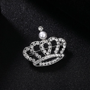Elegant silver crown brooch pin with sparkling rhinestones and a white pearl accent
