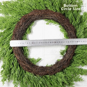 Close-up of measuring natural vine base diameter 26cm for green pine needle wreath