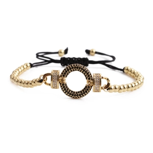 Detailed shot of gold-beaded bracelet featuring black zircon and adjustable cord