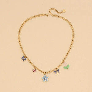Detailed shot of gold butterfly and colorful enamel flower pendants on a stainless steel chain