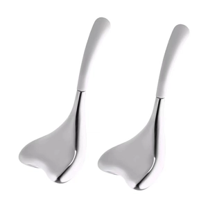 Macro detail of facial cooling globes featuring polished stainless steel and white handles