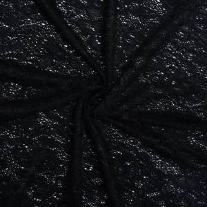 Close-up of black lace fabric featuring intricate hollow floral patterns and textures