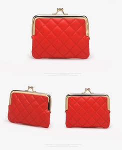 Detail view of red quilted PU leather coin purse with golden metal frame clasp closure