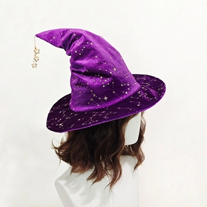 Detail of purple velvet witch hat with gold star patterns and hanging metal pendants