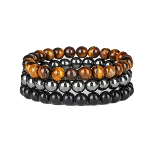 Detailed stack of tiger eye, hematite, and obsidian beaded bracelets on white background