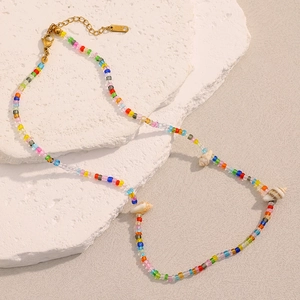 Detailed macro view of 18K gold plated K18 tag and colorful bohemian bead necklace