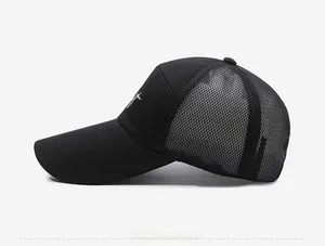 Side view of black breathable mesh trucker hat with white embroidery and curved brim