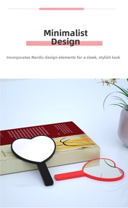 Detailed view of red and black heart-shaped hand mirrors with ergonomic long handles