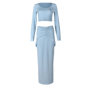 Detail of light blue knitted cropped top and matching maxi skirt with side pockets