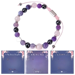 Detail of beaded pink quartz bracelet with heart charm and three unique greeting cards