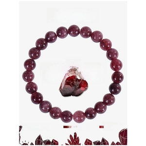 Detail of dark red garnet beaded bracelet with raw gemstone and healing energy card