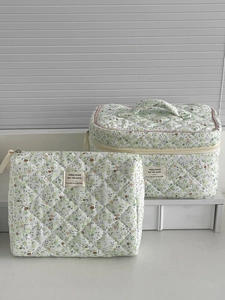 Set of two floral green quilted pouches including a makeup bag and travel toiletry bag