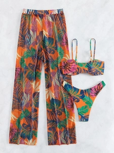 Flat lay of a three-piece orange tropical leaf print bikini set with mesh beach pants