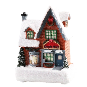 Christmas glowing resin candy house miniature ornament with snow texture on white background