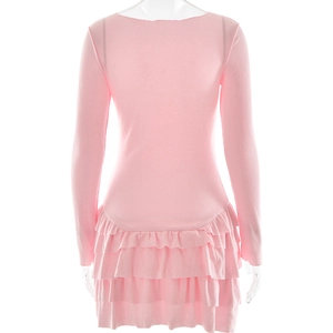 Detail view of the pink knit dress featuring tiered layered ruffles on the back hemline