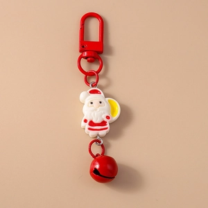Close-up of a festive Christmas Santa Claus keychain with a red metal clasp and bell