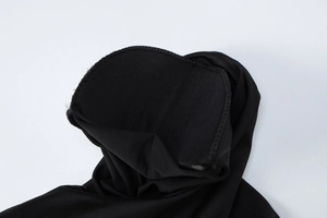 Close-up detail of the black mock neck collar and fine stitching on the slim dress