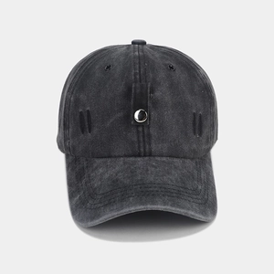 Detail of washed charcoal denim baseball hat with silver metal button and stitched vents